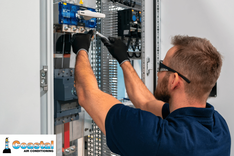 Man checking electrical panel for furnace power issue